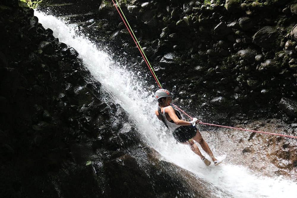 Rappelling down a waterfall.